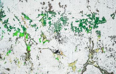 Obraz premium Abstraction of crumbling graffiti on a city street wall. Colorful abstract background. Old, cracked, peeling paint on the wall as a background.