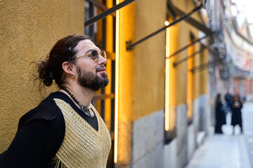 Latin transgender man posing in city street with stylish outfit