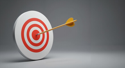 Target with arrow hitting the center against a gray background  