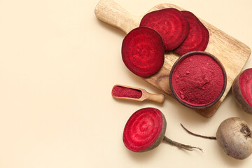 Bowl and scoop with beet powder on light background with space for text