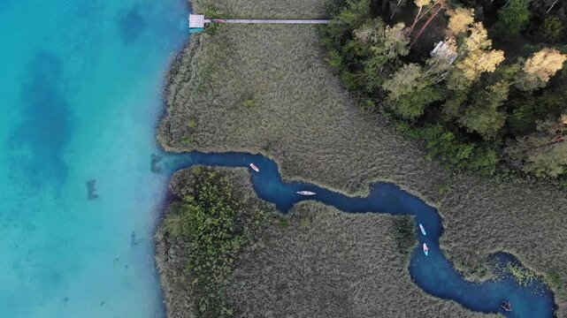 Austria drone view. Meanders among reeds on Lake Faak (Faaker See) in Carinthia state.
