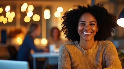A confident woman smiles in a supportive creative agency environment