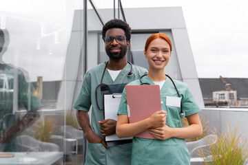 Red haired woman and African American man therapists in hospital office