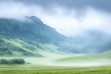 Misty mountain valley scene. Lush green valley enveloped by soft, hazy mist, with rolling hills and distant mountains
