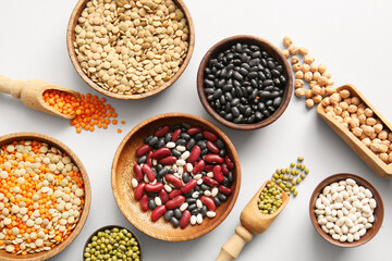 Composition with different raw legumes on light background