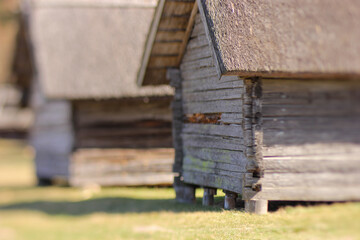 Old wooden houses in the countryside. Selective focus, shallow depth of field.