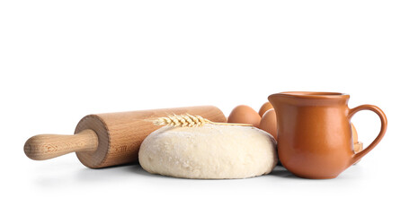 Composition with wooden rolling pin, dough and ingredients isolated on white background