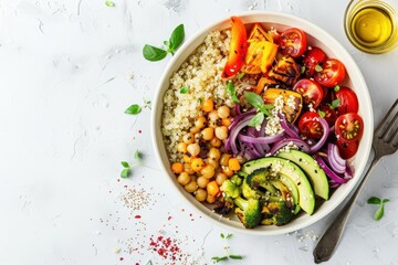 Colorful vegan buddha bowl featuring quinoa and roasted vegetables on a clean white background