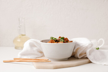Bowl with pieces of fried tofu cheese and micro green on white background