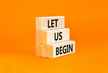 Let us begin symbol. Concept words Let us begin on beautiful wooden blocks. Beautiful orange table...