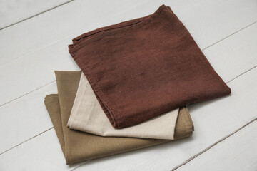 Different napkins on white wooden background