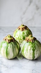 Naklejka premium Striped Green Eggplants on Marble Surface, Fresh Produce Photography