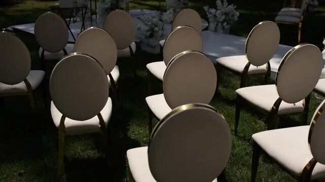 white chairs for a wedding ceremony with decor
