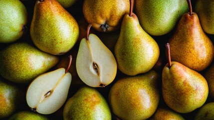 Fresh pears, whole and halved, display a vibrant color palette