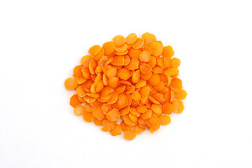 Heap of red split lentils on white background