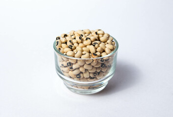 Black-eyed peas in a Glass bowl Isolated on a white background. Black-eyed peas, also known as black-eyed beans or cowpeas, are a type of legume. Organic edible bean.