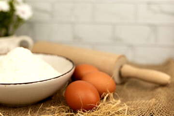 Baking products - flour, eggs. Flour and eggs on the table close-up