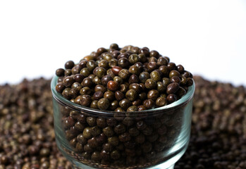 Closeup shot of Organic Black Peas in a Glass Bowl isolated on a white background. Black-eyed peas also called parched peas or dapple peas or Kala Vatana Desi Black Peas.