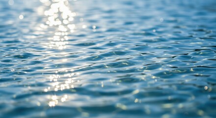 A close-up of a beautifully clear water surface with soft ripples and shimmering reflections of sunlight