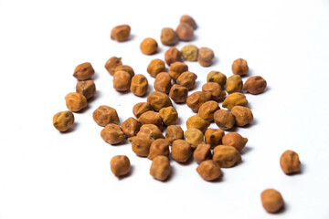 Small amount of Organic Brown Chickpeas Isolated on a white background. Black chickpeas, also known as kala chana, Bengal gram,Egyptian pea.
