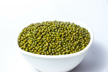 Green Moong Dal beans in a White Bowl Isolated on a white background. The mung bean or green gram (Vigna radiata).
