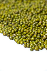 Vertical shot of Green Moong Dal beans Isolated on a white background. The mung bean or green gram (Vigna radiata).