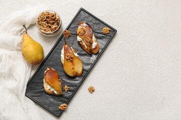 Plate of pear bruschetta with ricotta cheese and walnuts on white background