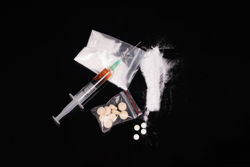 Syringe with drugs dose on black background. Narcotic substances in spoon. powder in plastic bag. Drugs concept on dark place. Heroin narcotic crime. Danger addict problem criminal