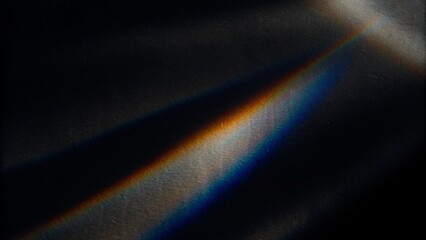 Rainbow sun flares on a black background, colorful glare and shine, light rays on sparkling surface. Rainbow refraction of bright sunlight on dark fon. Natural light effects, trend aesthetic