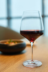 Close-up of glass of red wine standing on table in the restaurant