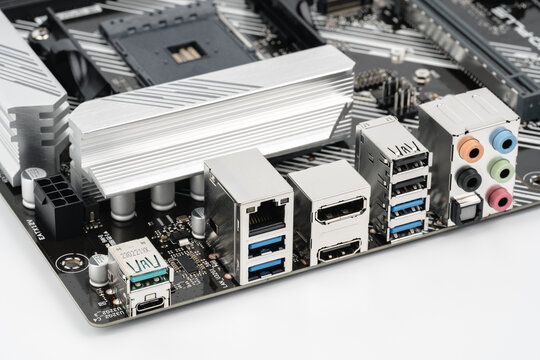 The back of a modern motherboard with a large set of ports for connecting peripheral equipment for a desktop computer. HDMI, Display Port, USB, USB Type C, Ethernet, Audio ports. Selective focus