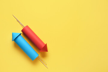 Blue and red firework rockets on yellow background