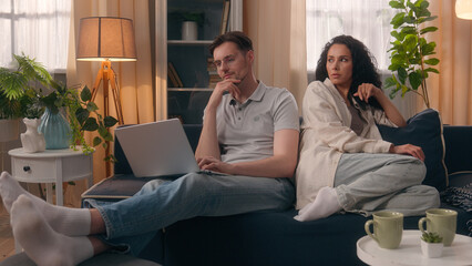 Caucasian couple problem busy freelancer man male husband boyfriend gadget addict playing video...