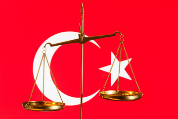 Golden scales of justice against the background of the Turkish flag
