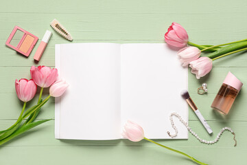 Blank fashion magazine with flowers, cosmetics and jewellery on green wooden background. Spring season concept