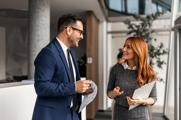 Professional Office Discussion Between Colleagues Smiling and Sharing Ideas