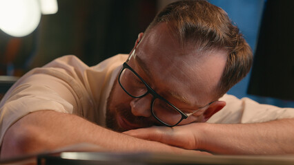 Caucasian man business guy businessman male workaholic in dark night office overworked overtime...