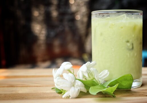 Ice matcha green tea with milk and white jasmine flowers