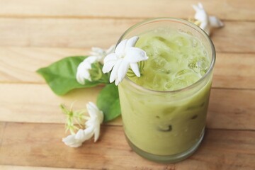 Ice matcha green tea with milk and white jasmine flowers