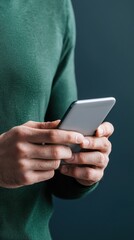 Person Holding Smartphone in Hands with Dark Background