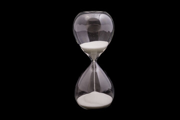 Elegant hourglass with flowing sand against a dark background showcasing time