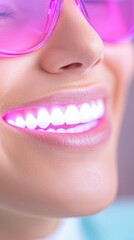 Fototapeta premium Close Up of Woman's Bright Glowing Smile Pink Light Teeth Whitening