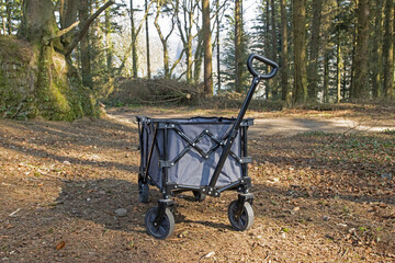 Wheeled camping trailer going through forest