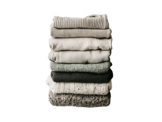 Stack of cozy folded sweaters, white isolate background