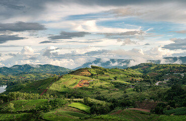 Landscape of rural agricultural hill with sunlight shine in rainy season at Khao Kho