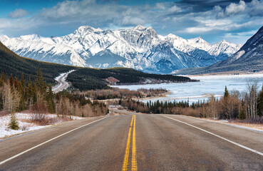Scenery of Road trip on highway with rocky mountains and frozen lake at Icefields Parkway