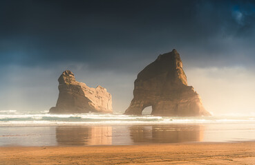 Wharariki beach with Archway islands on Tasman sea, West of Cape Farewell at South Island of New Zealand