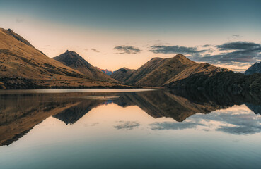 Scenery of Moke Lake reflect with mountain range in the evening at New Zealand