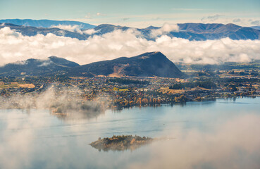 Scenic foggy mountain from summit of Roys Peak with Lake Wanaka in the morning at New Zealand