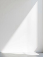 Bright sunlight dramatically illuminates a minimalist white wall creating a serene atmosphere. AI Generated